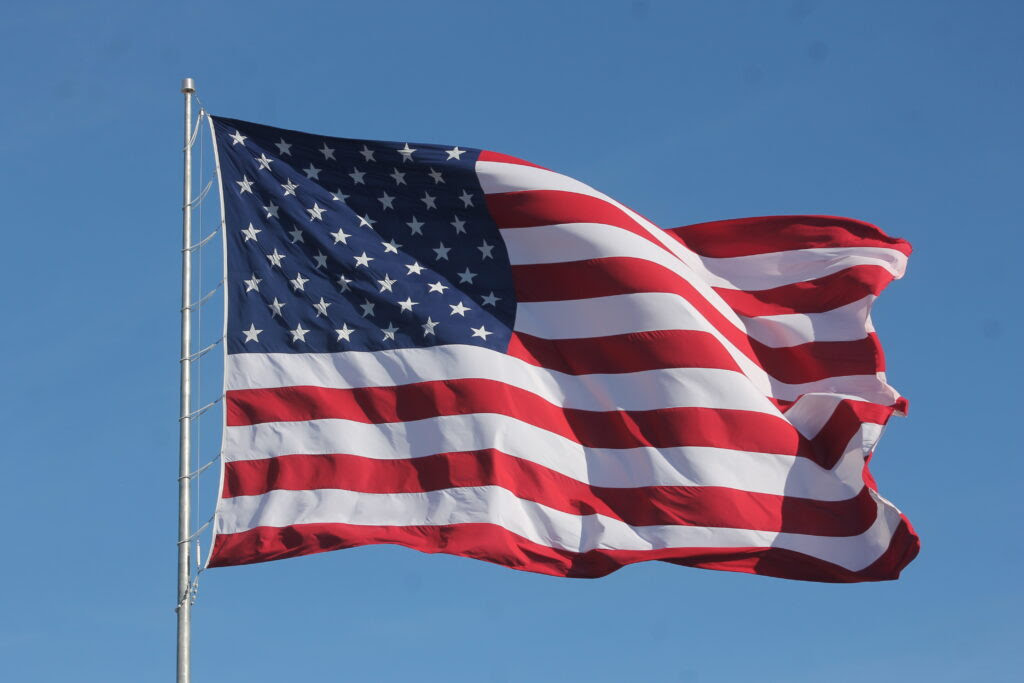 American Flag Waving on a Flag Pole 1024x683 1